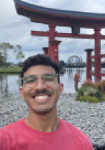 Student smiling and posing with a foreign building